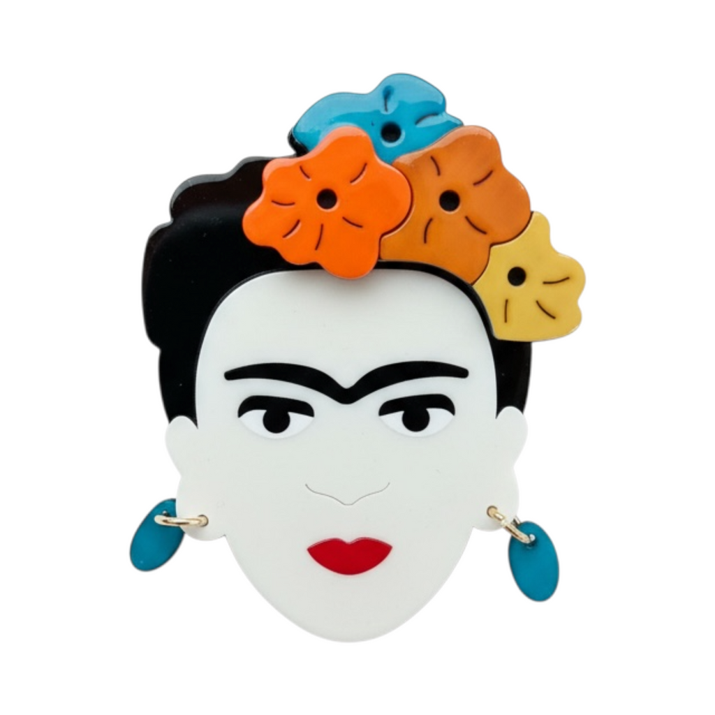 Broche TOKYO de La Mariposa, color naranja, con rostro de mujer y tocado de flores. Vista frontal.